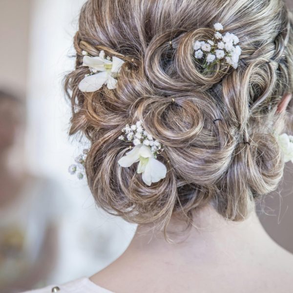 pexels-photo-355063-355063 Close-up of an elegant bridal hairstyle featuring delicate white flowers, perfect for a wedding day.