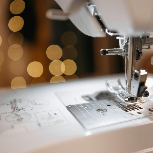 pexels-photo-6461142-6461142 Detailed view of a sewing machine needle and parts with bokeh background, showcasing precision engineering.