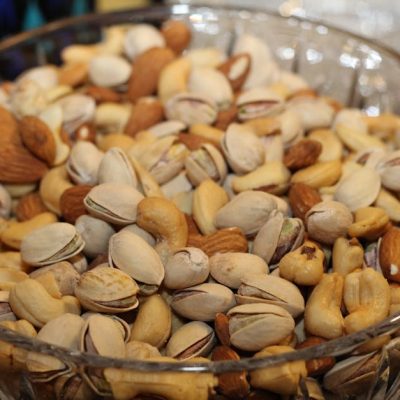 pexels-photo-86649-86649 A close-up view of a glass bowl filled with various mixed nuts, including almonds, cashews, and pistachios.